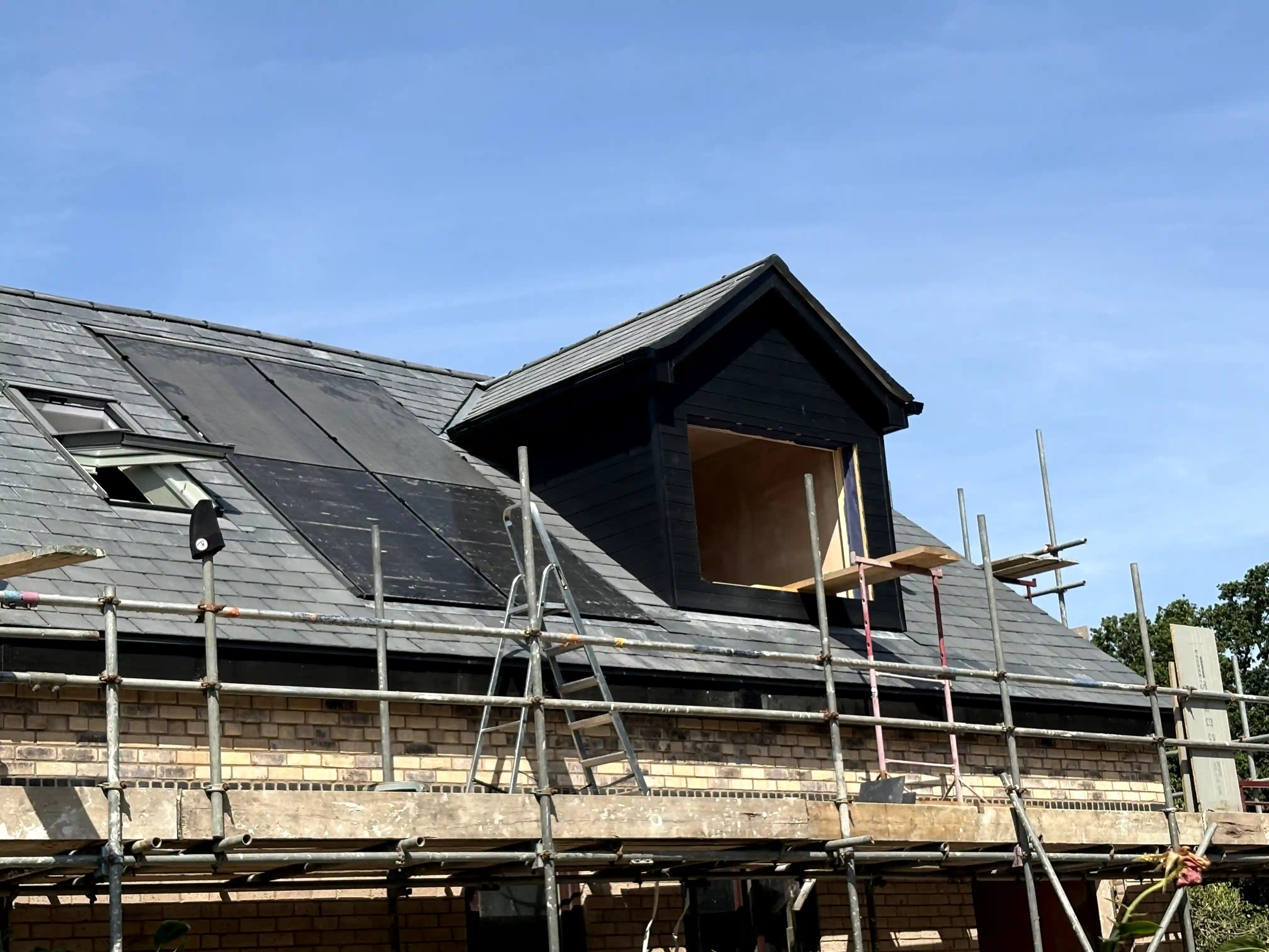 Natural slate new build — hip junction and dormer close-up